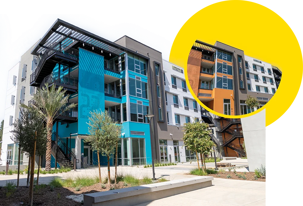 Modern apartment complex featuring white, gray, and bright blue panels, with an inset circular image showing the same building with orange paneling.