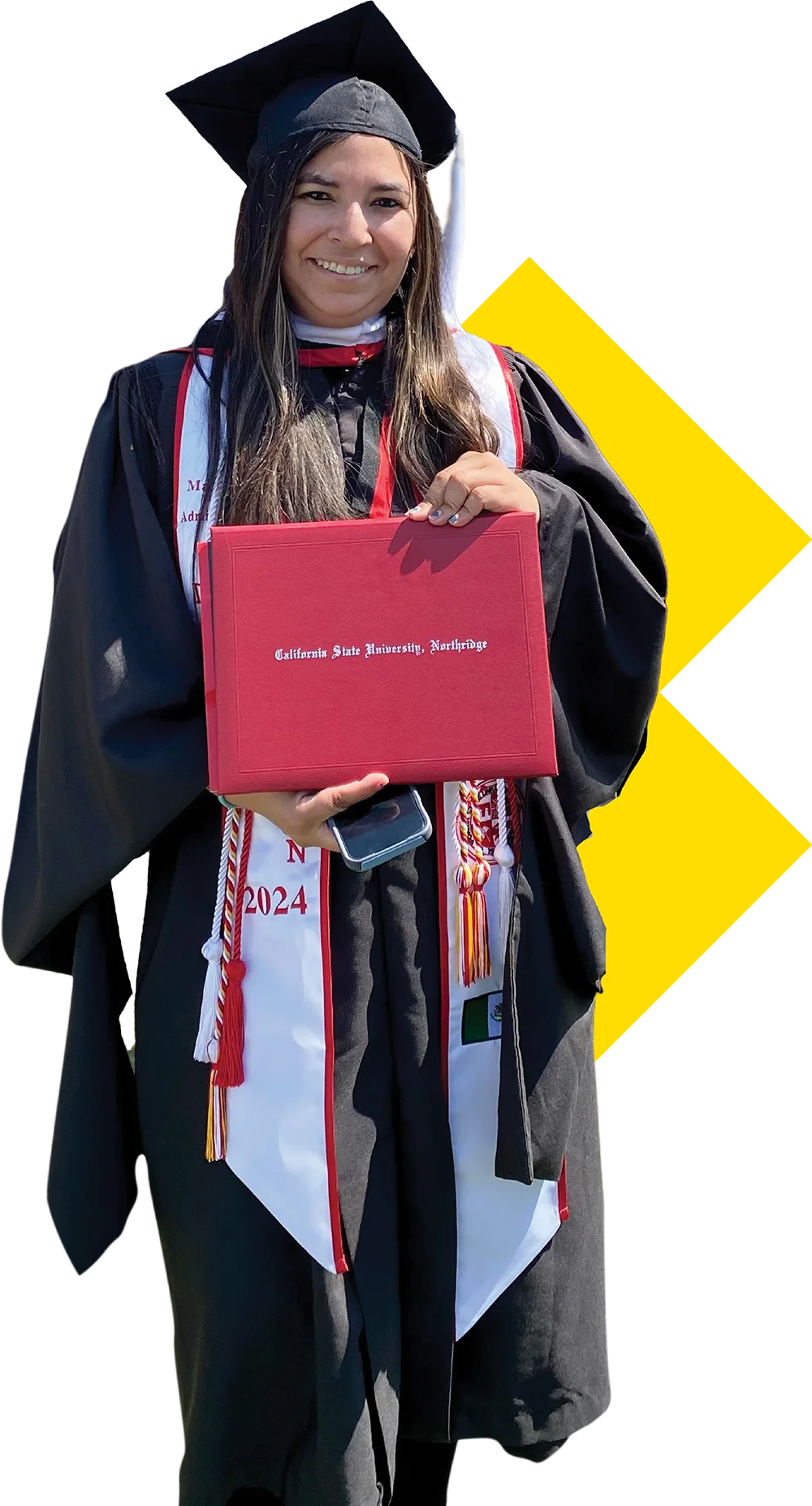 A smiling graduate in a black cap and gown holds up a red diploma cover with 'California State University, Northridge' visible.
