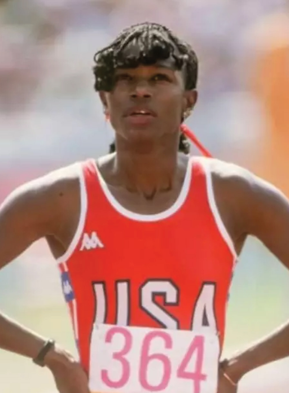 Valerie Brisco-Hooks wearing a red USA jersey with bib number 364 looking upward.