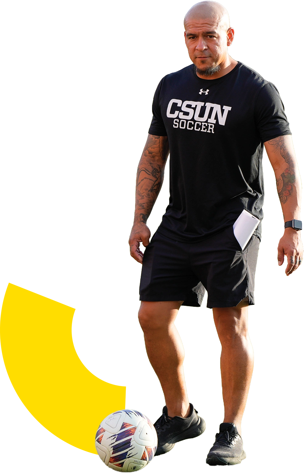 Rafael “Rafa” Garcia in a black CSUN Soccer shirt standing with a soccer ball at his feet.